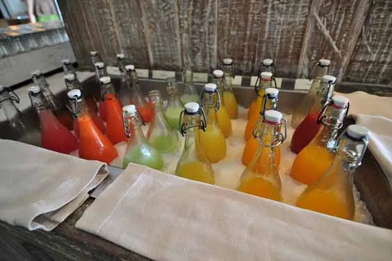 Glass juice bottles immersed in ice