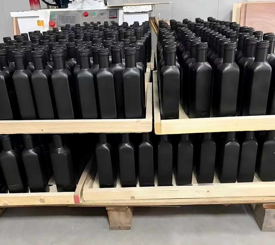 glass oil bottles on pallet